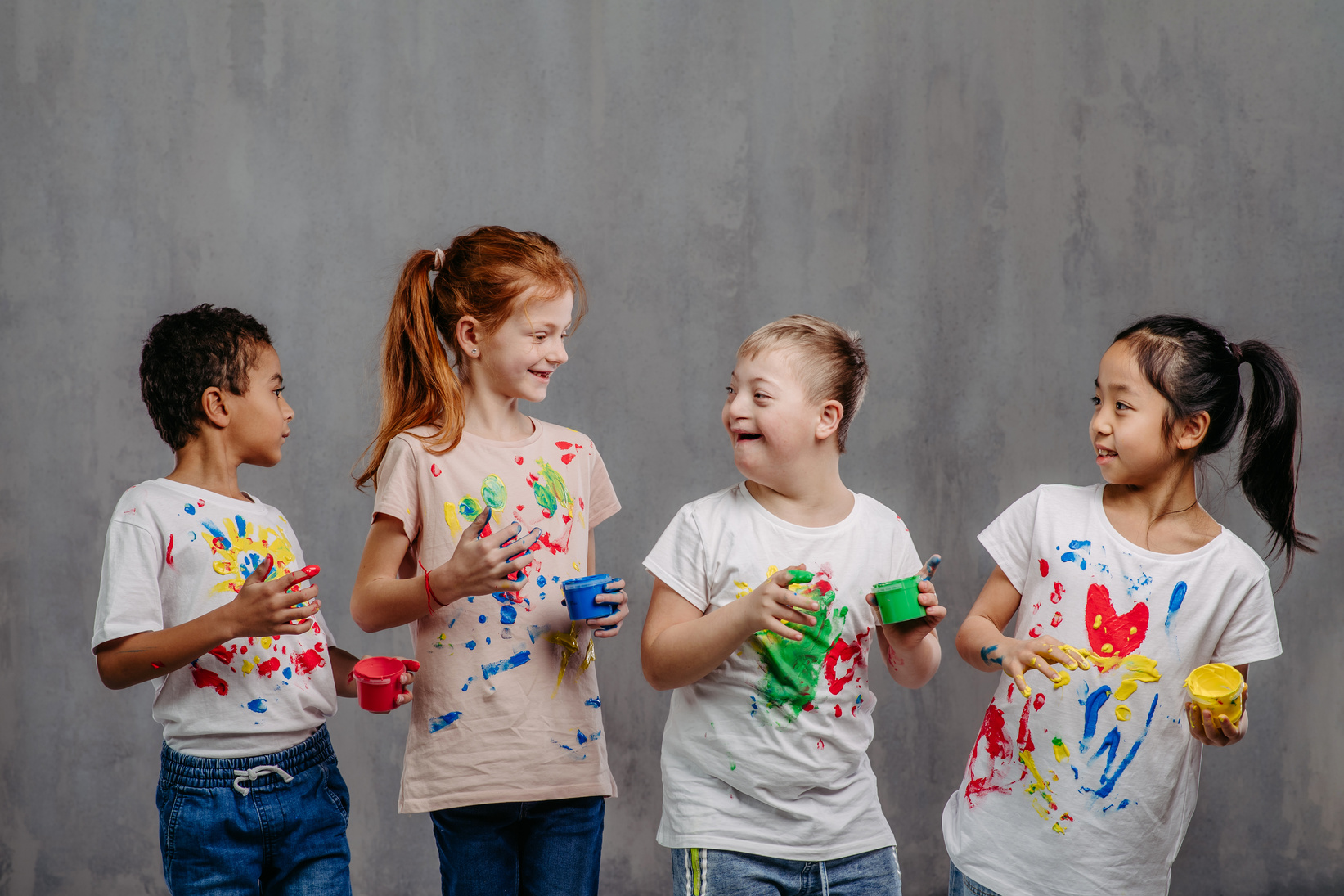 Child with Disability Finger Painting with Other Kids